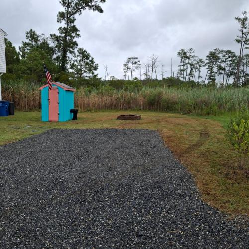a smallshed sitting in the middle of a field at Little Oyster Oasis in White Stone