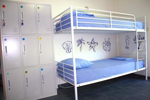 a bunk bed with blue pillows on the bottom bunk at TravelBreak in Podgorica