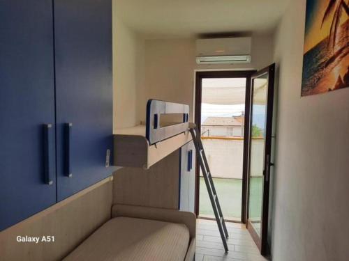 a small room with a bunk bed and a ladder at Appartamenti Miramare in Marina di Camerota