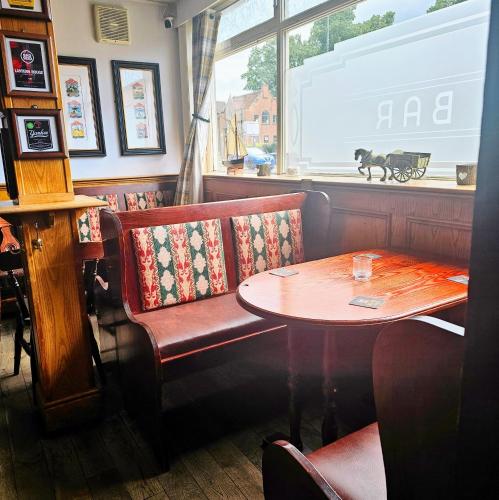 a restaurant with a table and a bench and a table at The Waggon & Horses in York