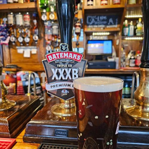 a glass of beer sitting on top of a bar at The Waggon & Horses in York