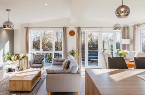 a living room with a couch and a table at Luxury lodge - St Helens in Isle of Wight