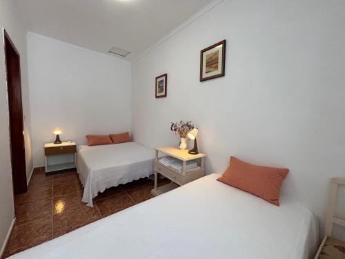 Giường trong phòng chung tại Jardim