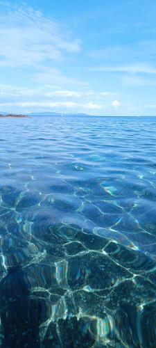 a large body of water with rocks in it at La Maisonnette in Rio Marina
