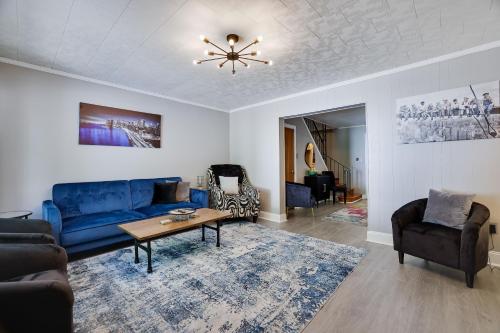 a living room with a blue couch and a table at Home on Broadway in Jim Thorpe in Jim Thorpe