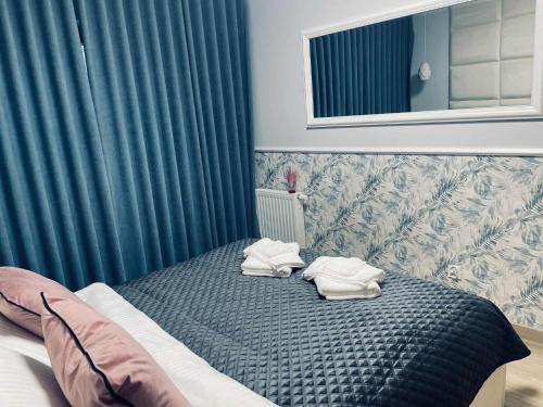 a bedroom with a bed with towels on it at Apartament NATALKA SPA ul Traugutta in Wrocław
