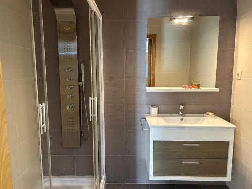 a bathroom with a sink and a shower at Apartamento Braguinha in Bragança