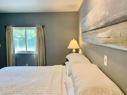 a bedroom with two beds and a window at Green Acre Motel in Lake George