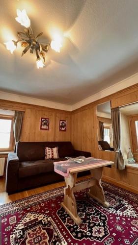 a living room with a couch and a table at Hotel Chasa Sofia in Scuol
