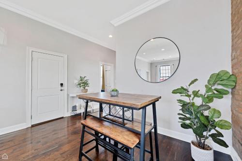 a dining room with a table and a mirror at Modern, Spacious 3br Apt Minutes To Downtown! in Chicago