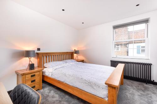 ein Schlafzimmer mit einem Bett, einem Stuhl und einem Fenster in der Unterkunft 93 High Street in Redbourn