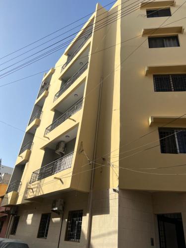 a tall building with a lot of windows at Appartement mariste près de auchan in Darou Rhamane