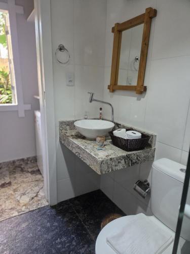 a bathroom with a sink and a toilet at Pousada Blue Ocean in Itacaré
