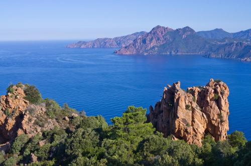 a view of a large body of water with mountains at Camping Le Sagone in Sagone