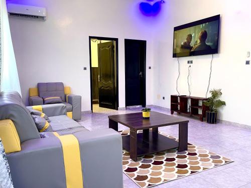a living room with two couches and a coffee table at Appartement Yoff Oasis in Dakar