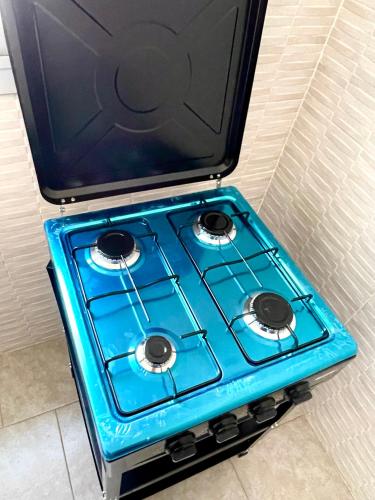 a blue stove top oven sitting in a room at Appartement Yoff Oasis in Dakar