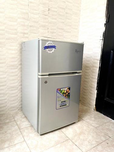 a refrigerator is sitting in a room at Appartement Yoff Oasis in Dakar