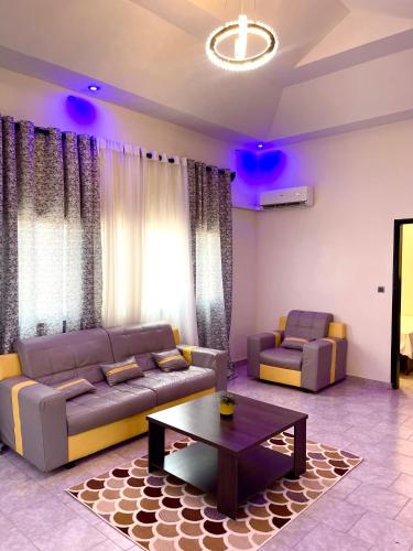 a living room with a couch and a coffee table at Appartement Yoff Oasis in Dakar