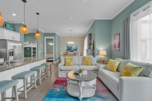a living room with a couch and a table at Little Lagoon Beach House by The Madison Liv Collection in Gulf Shores