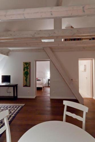 a living room with wooden floors and a white ceiling at Lijo in Gargždai