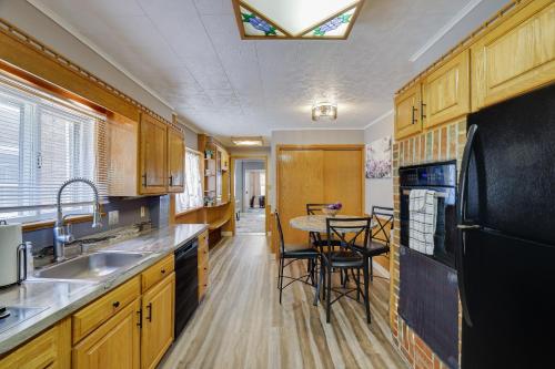 a kitchen with wooden cabinets and a table with chairs at Home on Broadway in Jim Thorpe in Jim Thorpe