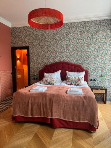 a bedroom with a bed with two towels on it at Billnäsin ruukki in Billnäs