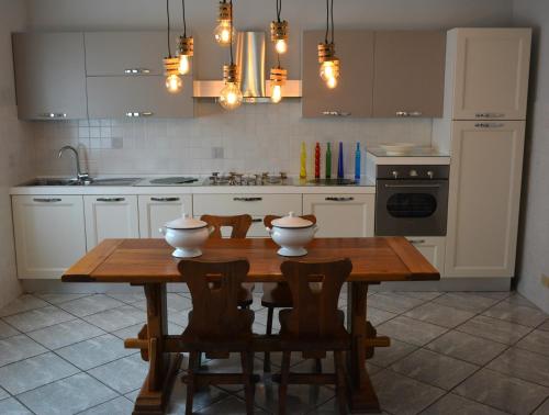 a kitchen with a wooden table with two bowls on it at Villa Luisa Design in Colle Val D'Elsa