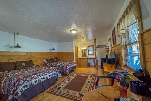 a hotel room with two beds and a table at Chinook Winds Lodge in Dubois