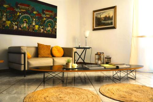 a living room with a couch and a coffee table at Villa Luisa Design in Colle Val D'Elsa