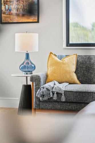 a living room with a couch and a lamp at Wave Haven Suites - 4BR-5BA Luxury - 2 Suites - Walk to Beach - Views in Cocoa Beach