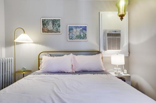 a bedroom with a bed with white sheets at Home on Broadway in Jim Thorpe in Jim Thorpe