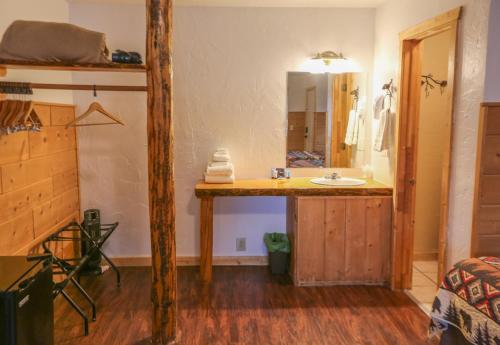 a bathroom with a sink and a mirror at Chinook Winds Lodge in Dubois