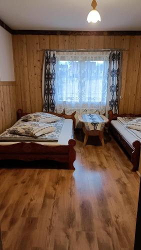 a bedroom with two beds and a window at Pokoje gościnne u Krupy in Murzasichle