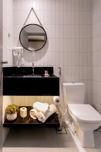 a bathroom with a sink and a toilet and a mirror at Simple Smart By Xtay - Novo, aconchegante e a 7min do Manaíra Shopping in João Pessoa