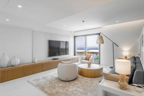 a living room with a couch and a tv at Villa Kaplankaya in Milas