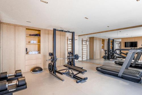 a gym with several treadmills and machines in it at Villa Kaplankaya in Milas