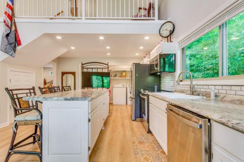 a kitchen with white cabinets and a counter top at Lakefront Retreat with Multi-Level Deck and Dock! in Alexander