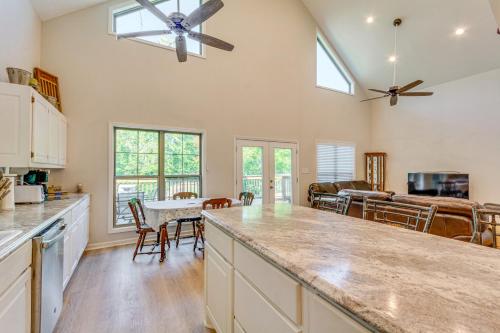 a kitchen and living room with a ceiling fan at Lakefront Retreat with Multi-Level Deck and Dock! in Alexander