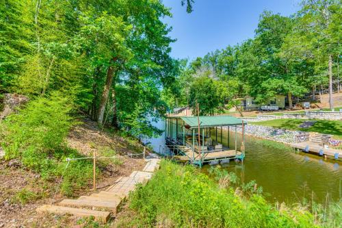 a house with a dock next to a river at Lakefront Retreat with Multi-Level Deck and Dock! in Alexander