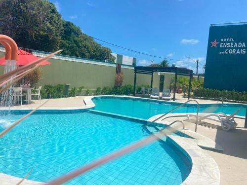 a large swimming pool in front of a building at Hotel Enseada dos Corais in Cabo de Santo Agostinho
