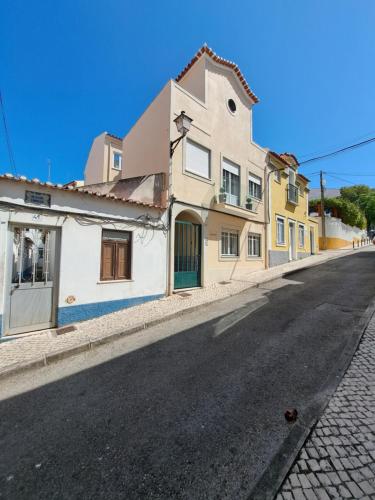 an empty street in a town with buildings at Apartamento Vista Mar -Marzaré in Nazaré