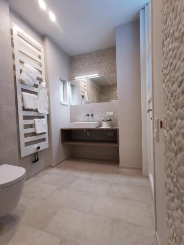 a bathroom with a white toilet and a sink at Refugium29a in Horn