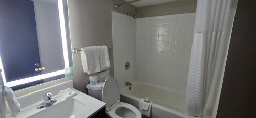 a bathroom with a toilet and a sink and a shower at Super 8 by Wyndham Laredo in Laredo