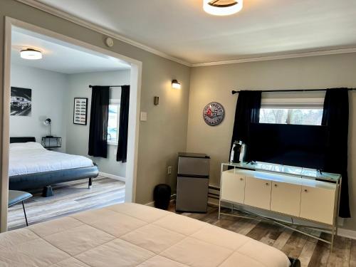 a bedroom with a bed and a large mirror at Green Acre Motel in Lake George