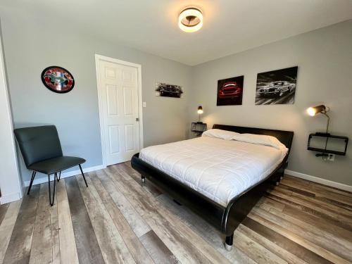 a bedroom with a bed and a chair in it at Green Acre Motel in Lake George