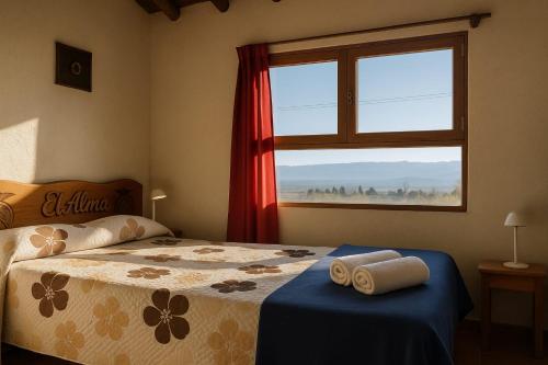 a bedroom with a bed and a window with a view at El Alma De Yacanto Hotel Boutique in Villa Yacanto