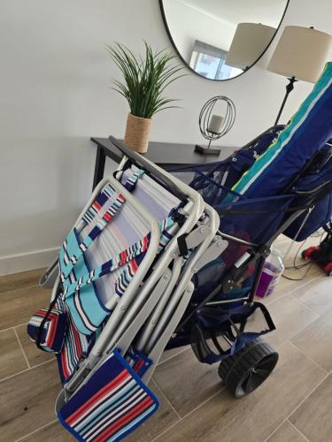 a stroller filled with hockey equipment in a room at 2BR-2BA with Pool Gym Beach Marbella Tower in Sunny Isles Beach