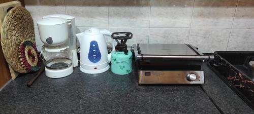 a counter top with a coffee maker and a blender at Athina-Milina in Milína