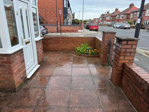 a sidewalk in front of a building with a window at Spacious Home Near City Centre in Kenton