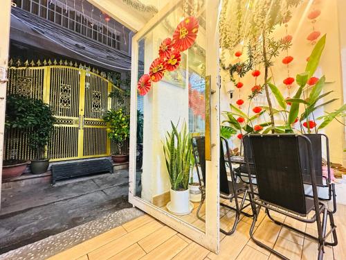 a room with a mirror and a table with plants at Nestin by Little Garden in Ho Chi Minh City